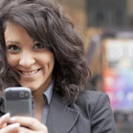 Smiling woman with mobile phone